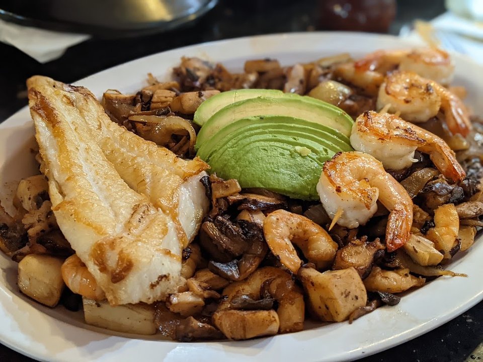 Printed menu with seafood and Mexican dishes.
